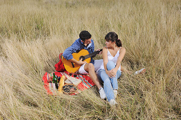 Image showing happy couple enjoying countryside picnic in long grass