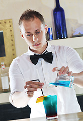 Image showing pro barman prepare coctail drink on party