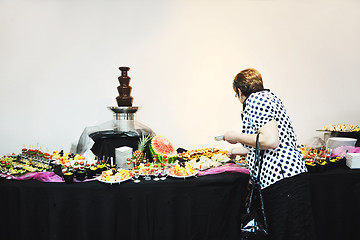 Image showing womanl chooses tasty meal in buffet at hotel