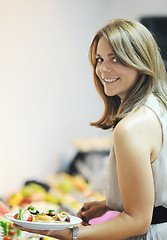 Image showing womanl chooses tasty meal in buffet at hotel