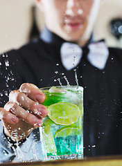 Image showing pro barman prepare coctail drink on party