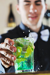 Image showing pro barman prepare coctail drink on party