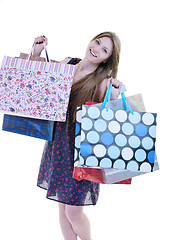 Image showing happy young adult women  shopping with colored bags