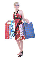 Image showing happy young adult women  shopping with colored bags