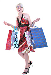 Image showing happy young adult women  shopping with colored bags