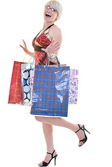 Image showing happy young adult women  shopping with colored bags