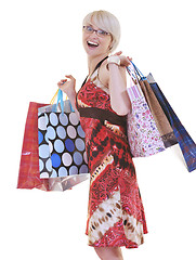 Image showing happy young adult women  shopping with colored bags