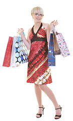 Image showing happy young adult women  shopping with colored bags