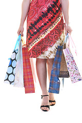 Image showing happy young adult women  shopping with colored bags