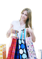 Image showing happy young adult women  shopping with colored bags