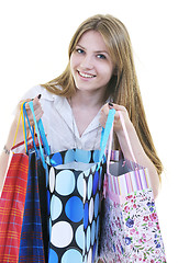 Image showing happy young adult women  shopping with colored bags