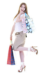 Image showing happy young adult women  shopping with colored bags