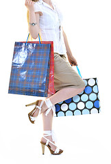 Image showing happy young adult women  shopping with colored bags