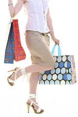 Image showing happy young adult women  shopping with colored bags