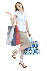 Image showing happy young adult women  shopping with colored bags