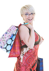 Image showing happy young adult women  shopping with colored bags