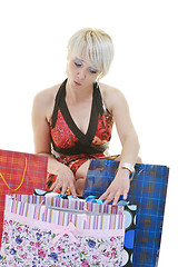 Image showing happy young adult women  shopping with colored bags