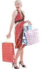 Image showing happy young adult women  shopping with colored bags