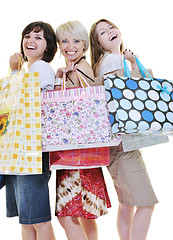 Image showing happy young adult women  shopping with colored bags