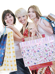 Image showing happy young adult women  shopping with colored bags