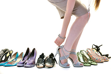 Image showing pretty young woman with buying shoes addiction, isolated on whit