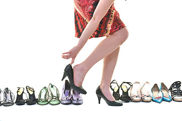 Image showing pretty young woman with buying shoes addiction, isolated on whit