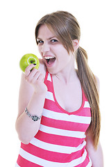 Image showing happy  young  woman eat green apple isolated  on white