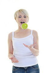 Image showing happy  young  woman eat green apple isolated  on white