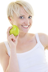 Image showing happy  young  woman eat green apple isolated  on white