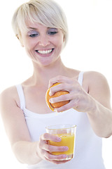 Image showing Young woman squeeze orange juice