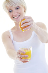 Image showing Young woman squeeze orange juice