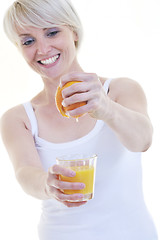 Image showing Young woman squeeze orange juice