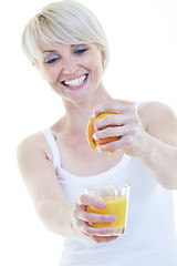 Image showing Young woman squeeze orange juice