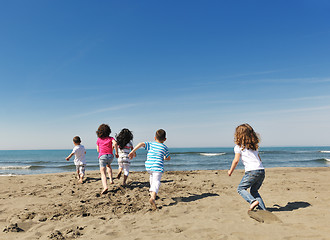 Image showing happy child group playing  on beach