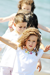 Image showing happy child group playing  on beach