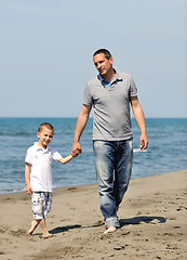 Image showing happy father and son have fun and enjoy time on beach