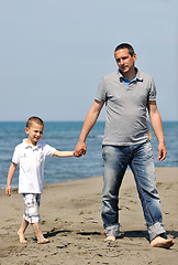 Image showing happy father and son have fun and enjoy time on beach