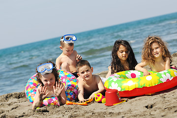 Image showing child group have fun and play with beach toys