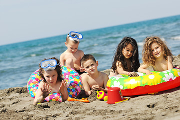 Image showing child group have fun and play with beach toys