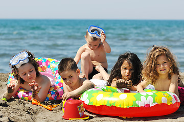 Image showing child group have fun and play with beach toys