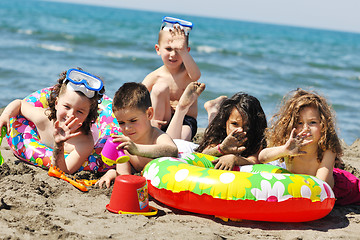 Image showing child group have fun and play with beach toys