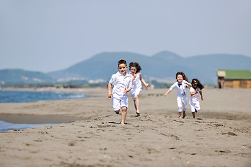 Image showing happy child group playing  on beach