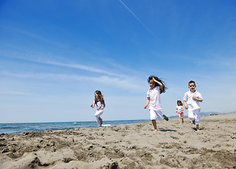 Image showing happy child group playing  on beach