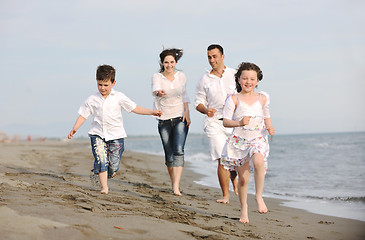 Image showing happy young family have fun on beach