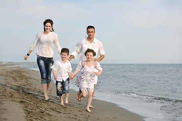 Image showing happy young family have fun on beach