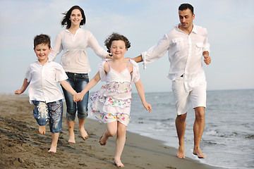 Image showing happy young family have fun on beach