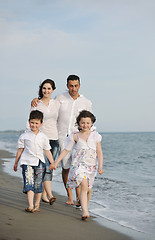 Image showing happy young family have fun on beach