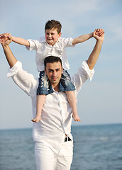 Image showing happy father and son have fun and enjoy time on beach