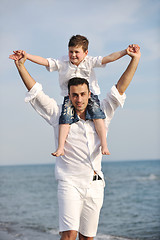 Image showing happy father and son have fun and enjoy time on beach