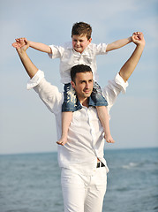 Image showing happy father and son have fun and enjoy time on beach